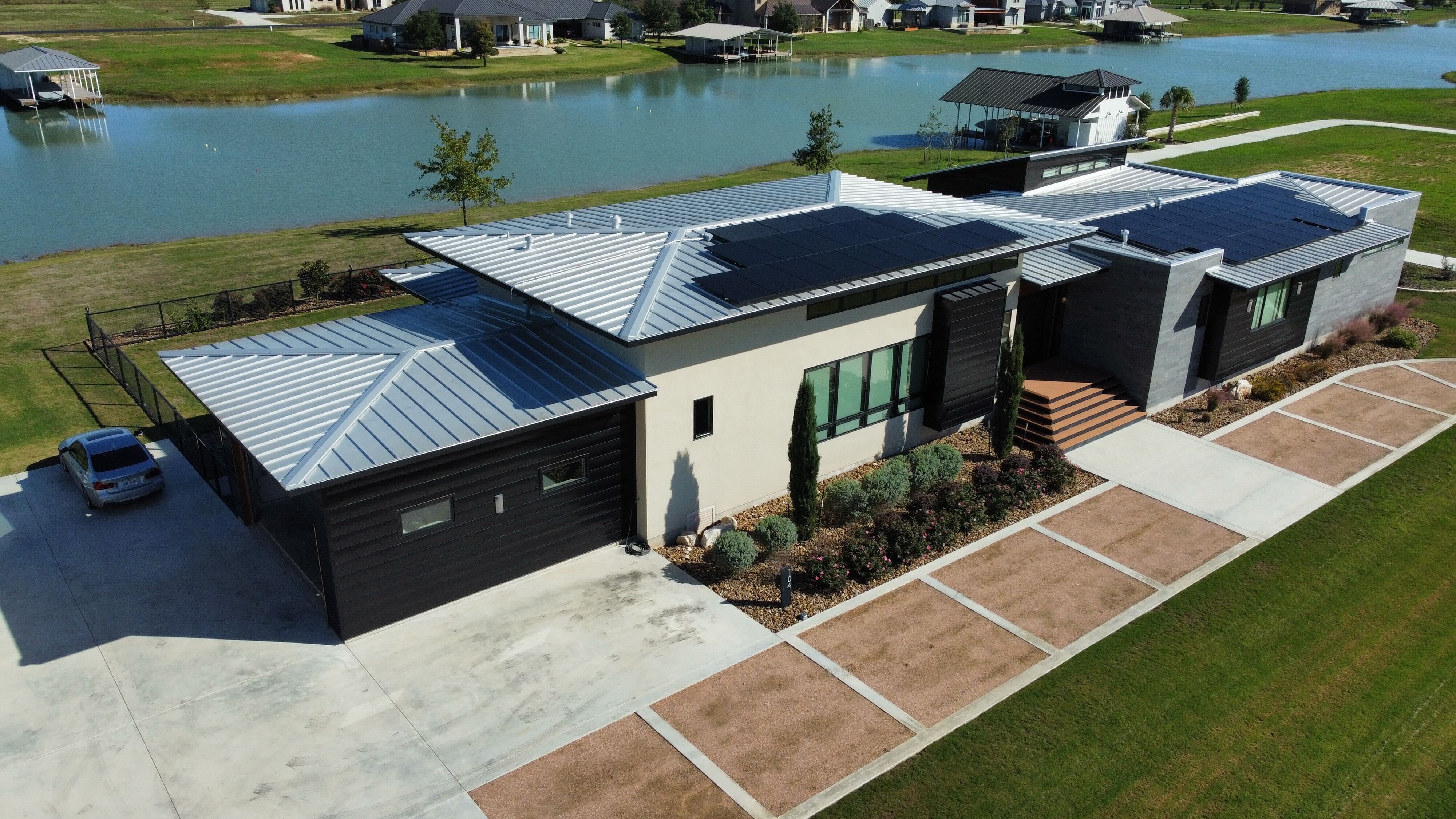 Aerial view of solar panels installed by roofio on a metal roof in Martindale, Texas