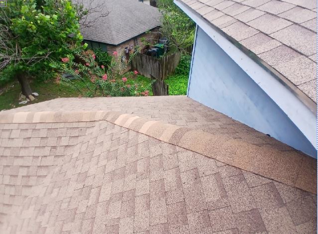 Completed shingle roof with a new ridge cap