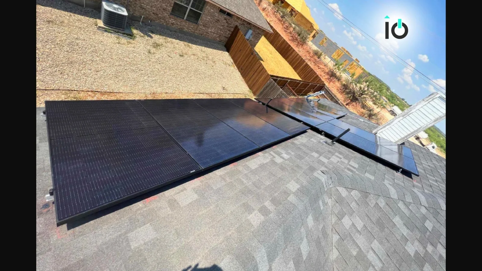 Solar panels installed over a new roof by roofio on a Texas home