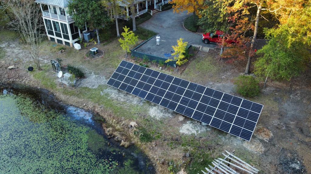 Ground-mounted solar array beside a spring-fed river in Woodville, Texas