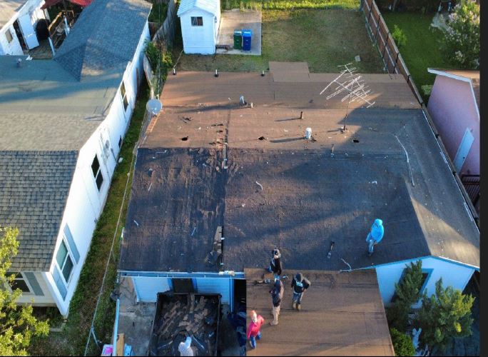 Aerial view of a worn roof being assessed before replacement in San Antonio, Texas