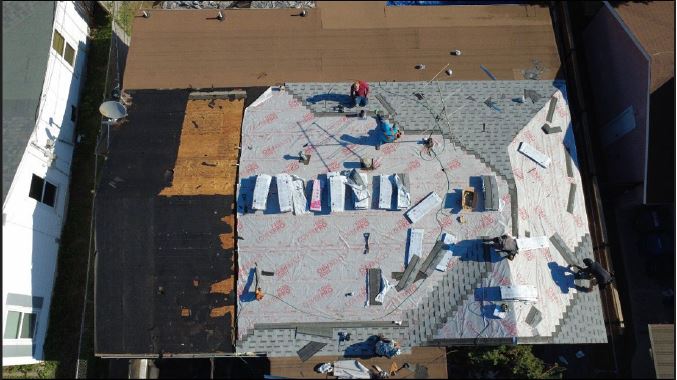 roofio crew replacing damaged roofing on a San Antonio home