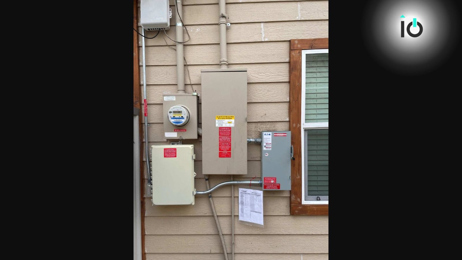 Electrical meter, disconnect and solar inverter on an exterior wall