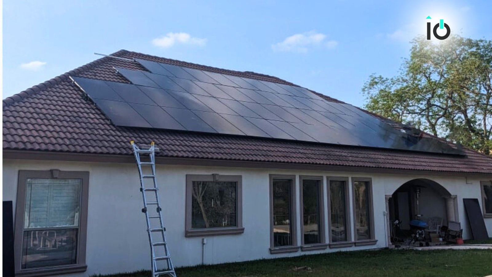 Solar panels installed across the roof of a stucco home