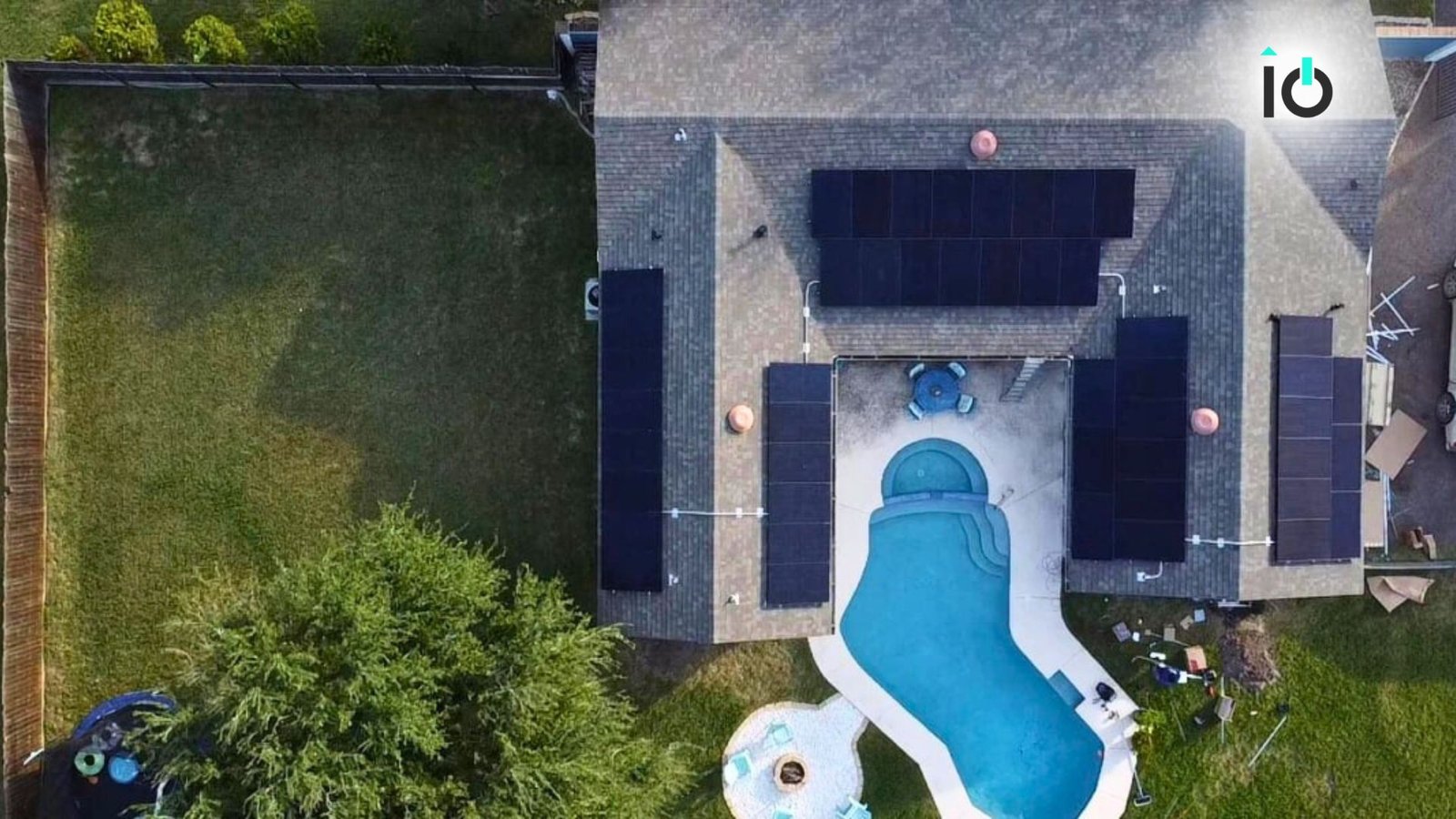 Aerial view of a home with a pool and rooftop solar panels