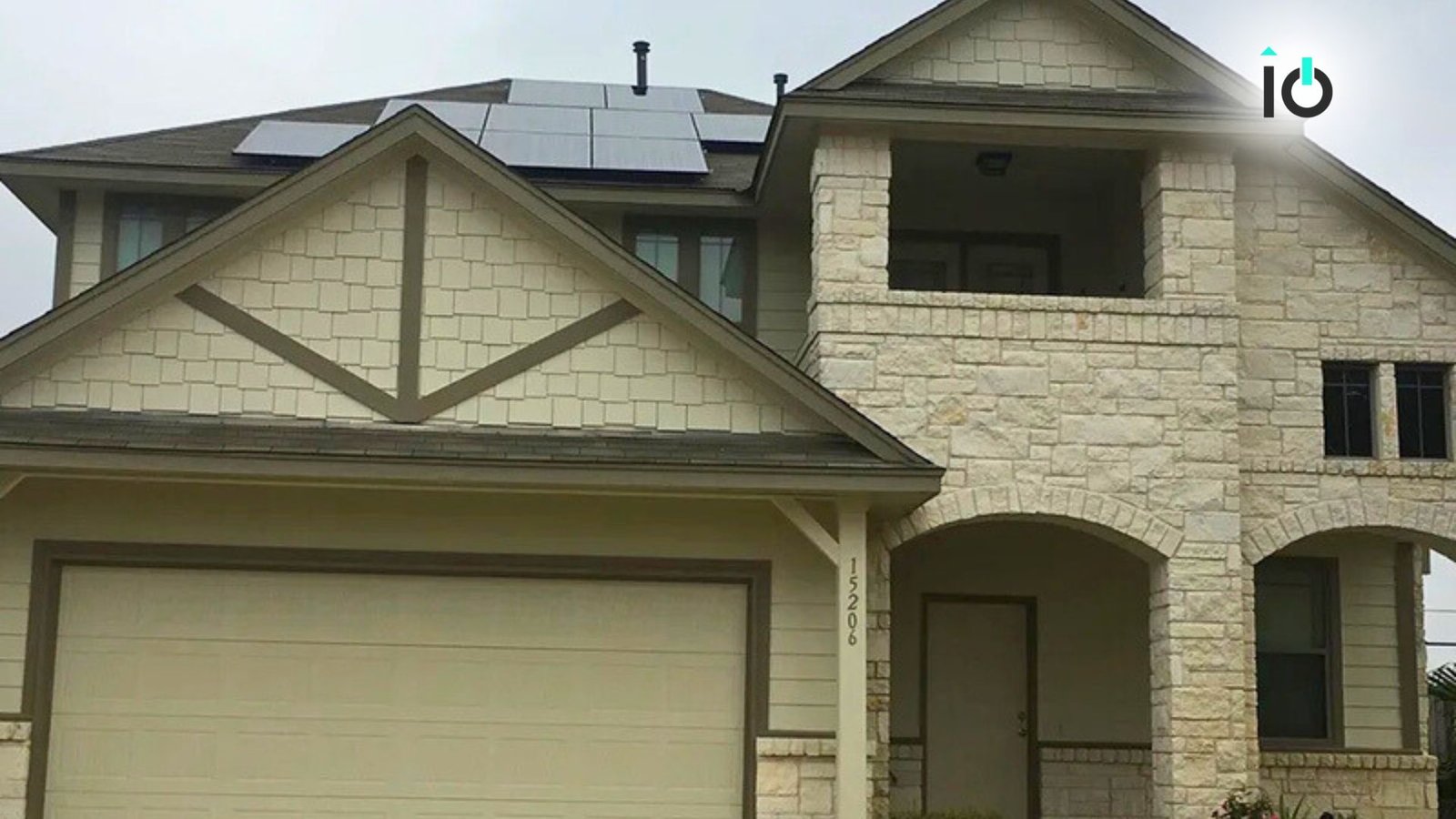 Two-story stone home with rooftop solar panels