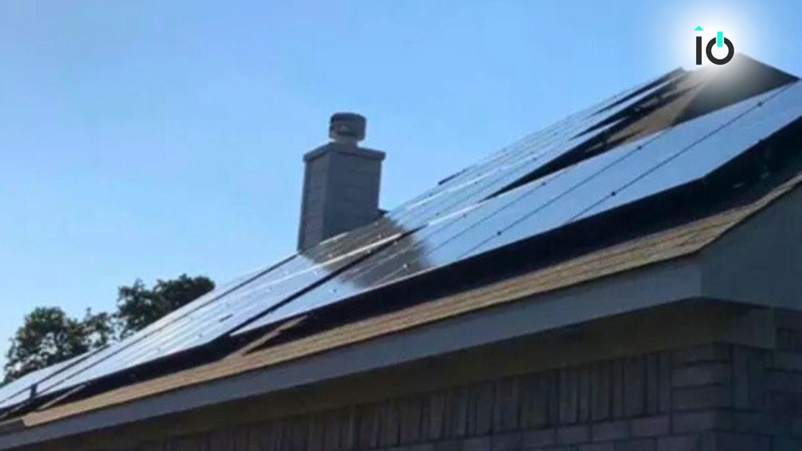 Solar panels on a roof beneath a blue sky