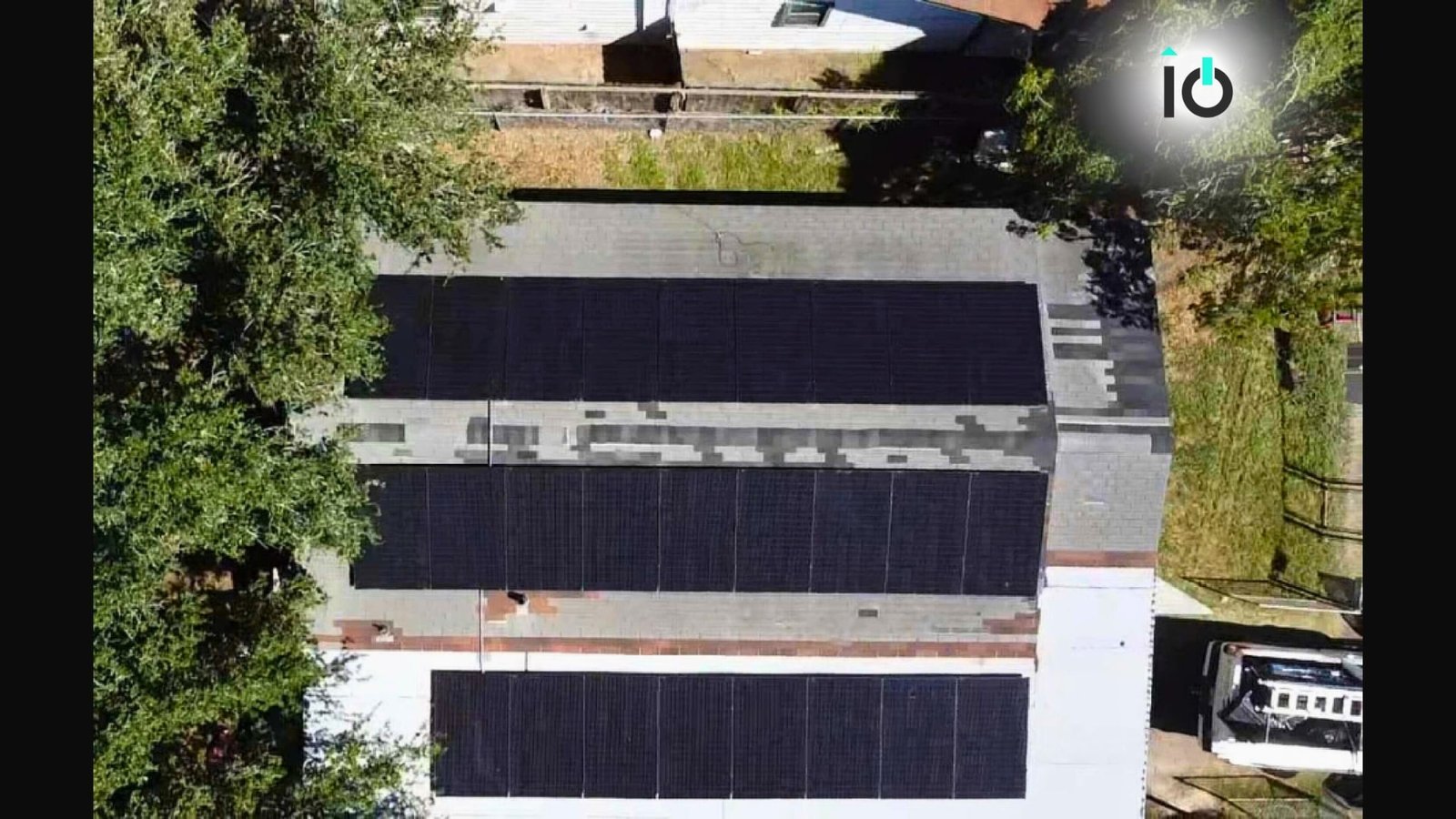 Aerial view of a suburban home with rooftop solar