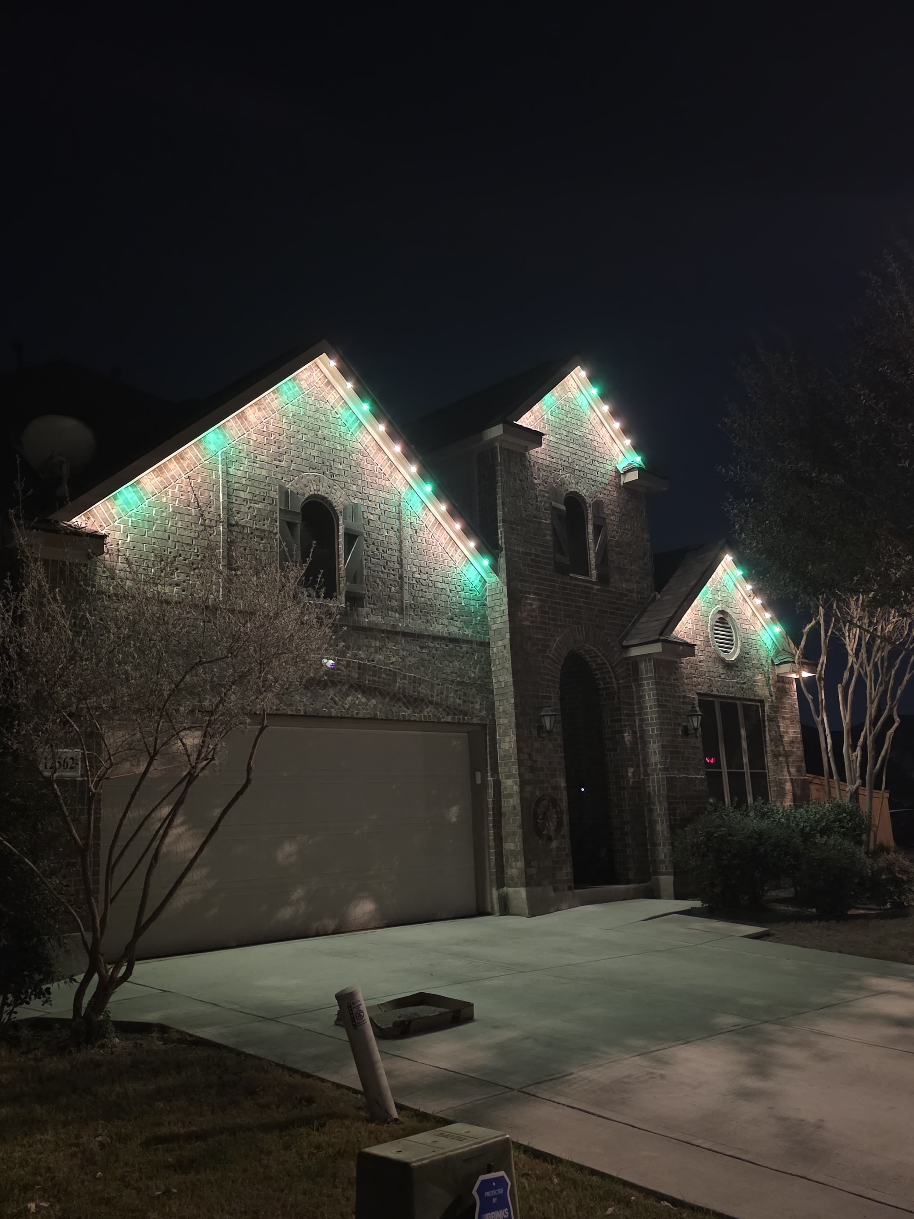 A home outlined in permanent lighting along every roof edge