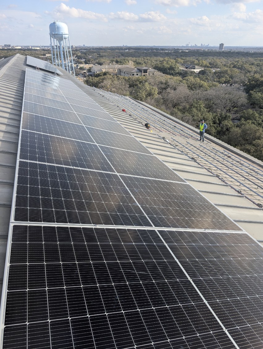 Commercial solar array running the length of a standing-seam metal roof