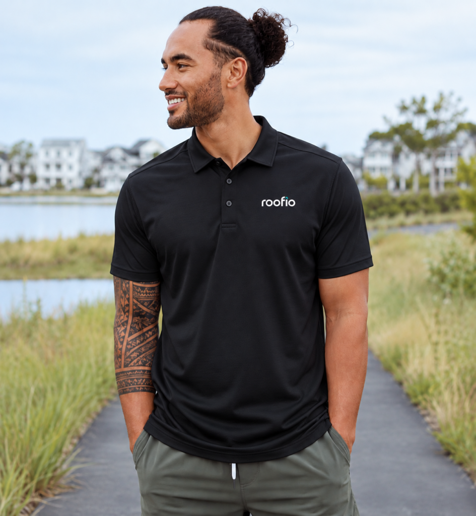 Model wearing the black Roofio Pinnacle Polo with a small Roofio logo on the left chest