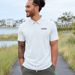 Model wearing the light-colored Roofio Palmer Polo with a small Roofio logo on the left chest